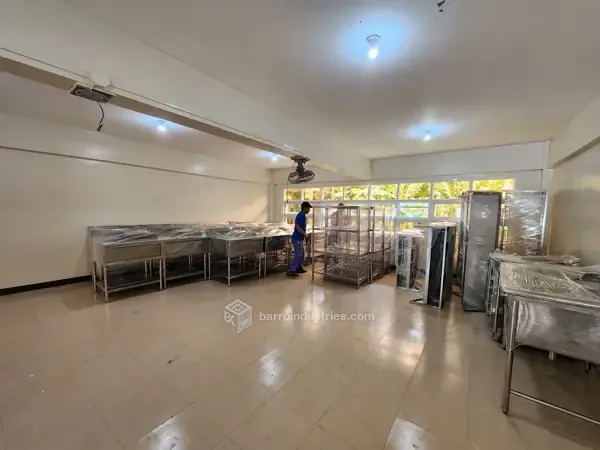 DMMMSU — room installed with stainless-steel tables, racks and shelving