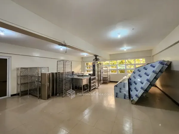 DMMMSU — installed stainless-steel tables and racks, wide view
