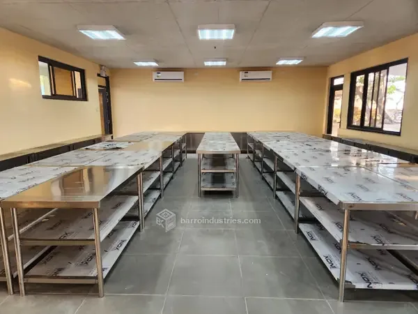 ISPSC 2026 — rows of stainless-steel work tables, wide view