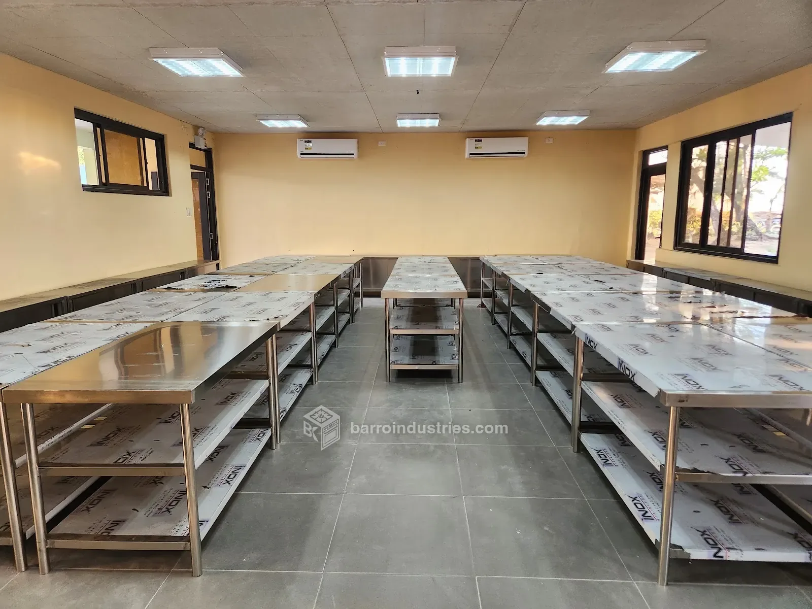 Rows of fabricated stainless-steel work tables