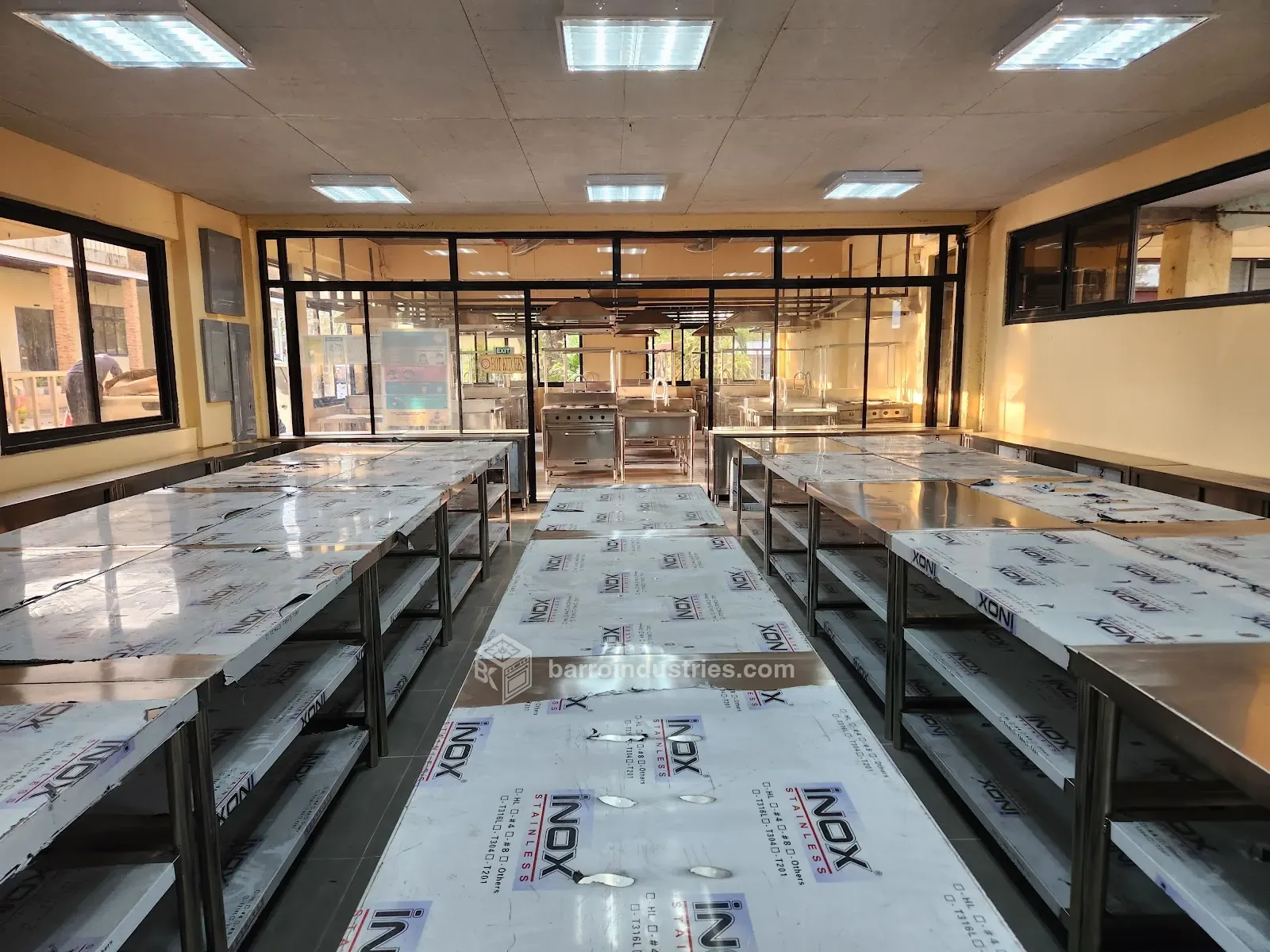 ISPSC 2026 — stainless-steel work tables with the protective film still on